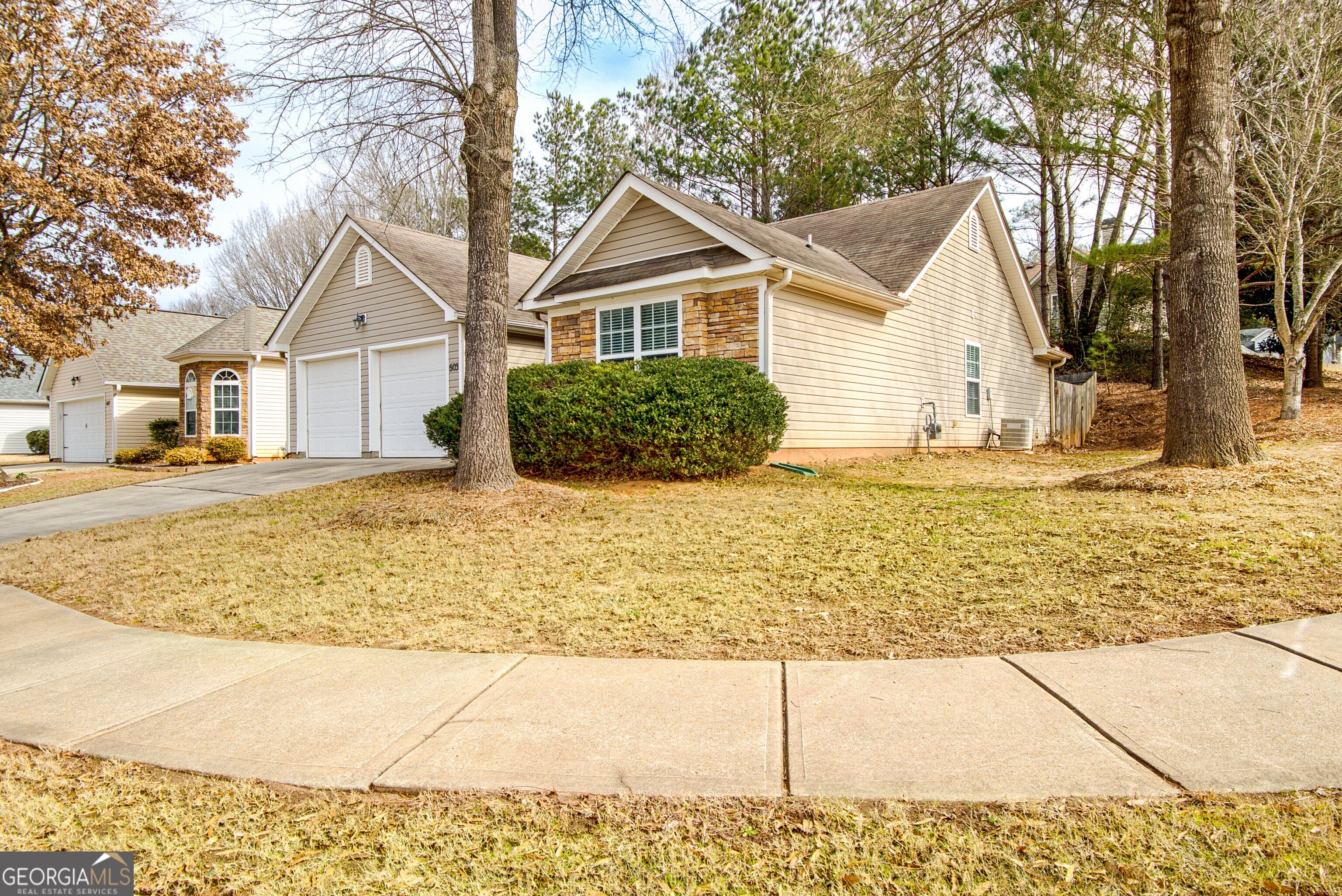 503 Hunterian Place Newnan, GA 30265 - Photo 3 of 28 a view of a yard in front of a house with large trees