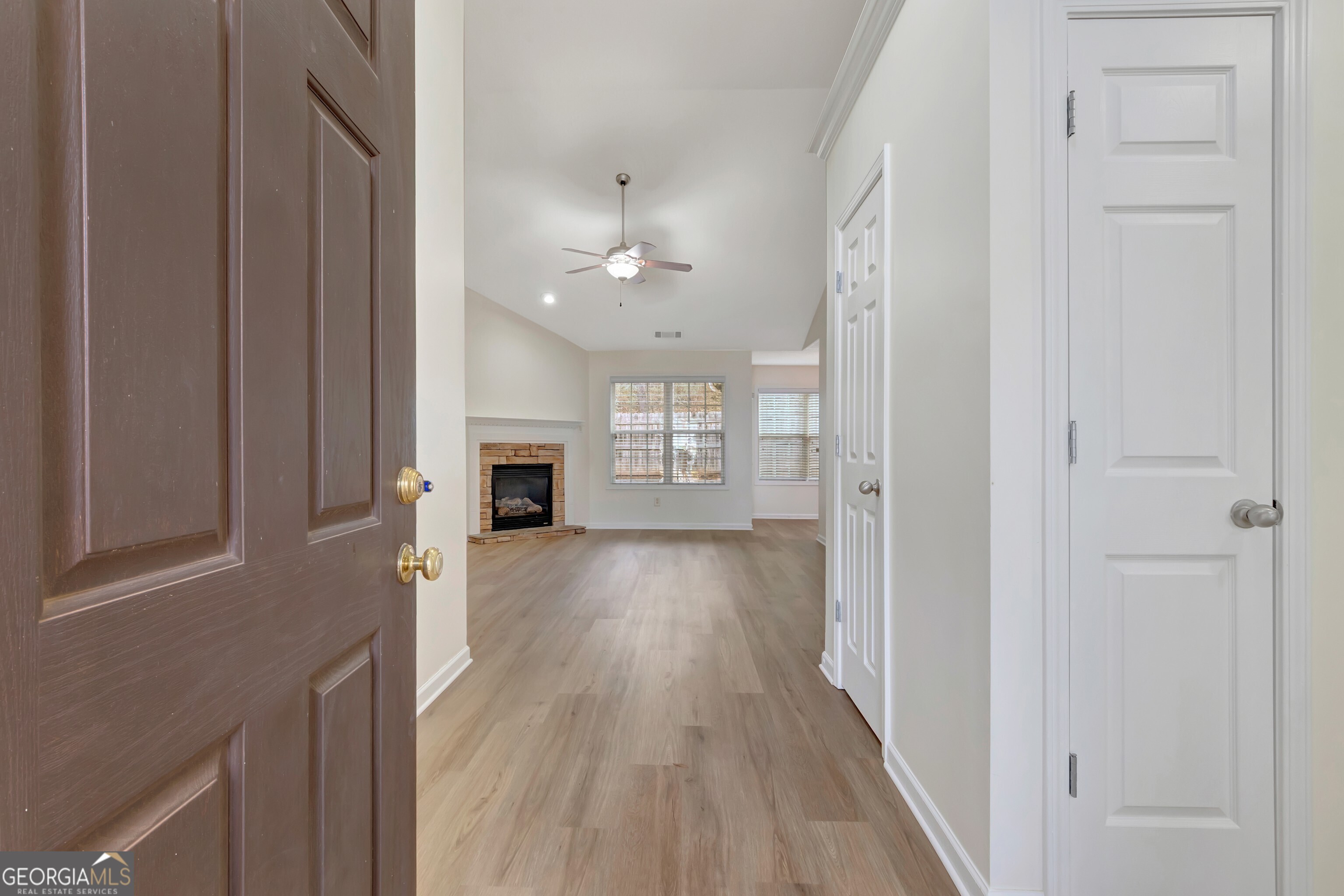 503 Hunterian Place Newnan, GA 30265 - Photo 5 of 28 wooden floor in an empty room with a fireplace