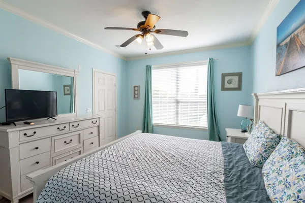a bedroom with a bed and a flat screen tv