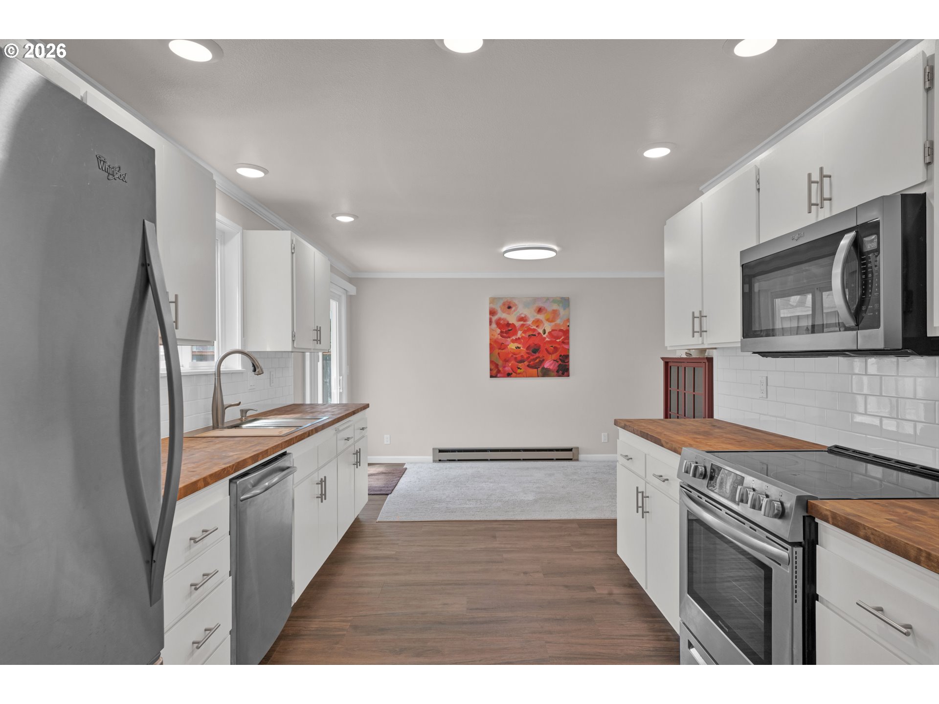 1142 9th Street Florence, OR 97439 - Photo 11 of 41 a kitchen with stainless steel appliances granite countertop a stove top oven a sink a counter space and cabinets