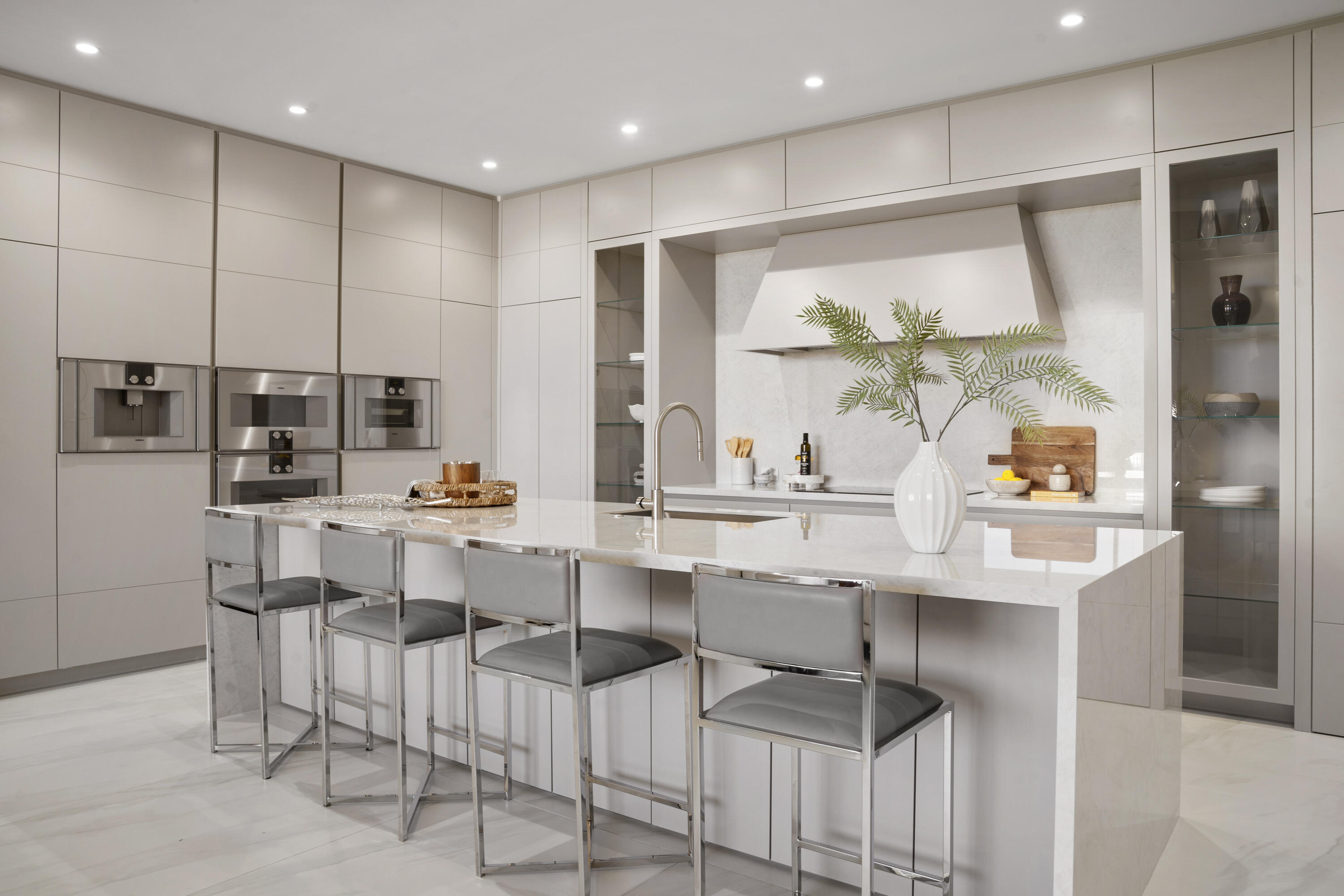 220 Southeast Mizner Boulevard, Unit PH921 Boca Raton, FL 33432 - Photo 12 of 21 a kitchen with a sink and chairs