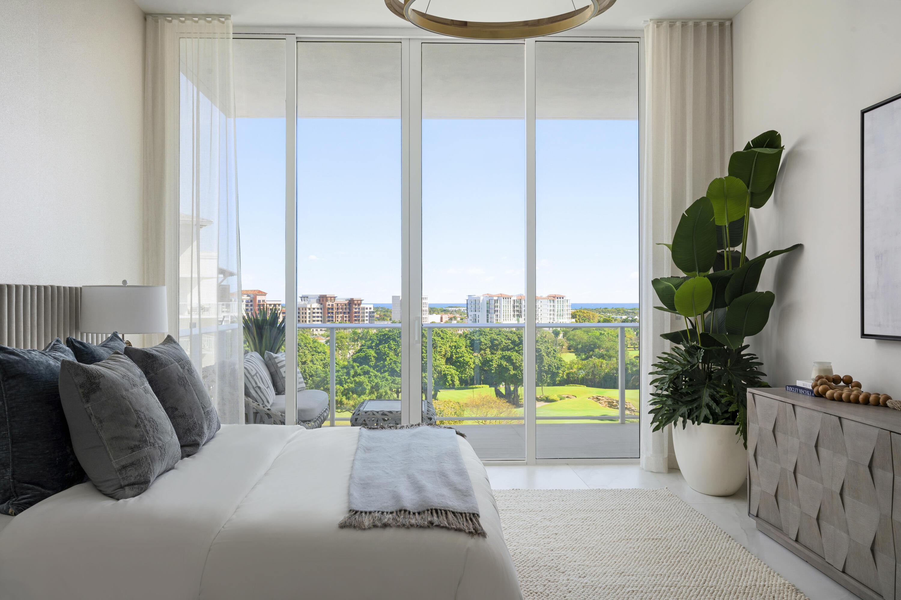 220 Southeast Mizner Boulevard, Unit PH921 Boca Raton, FL 33432 - Photo 5 of 21 a bed sitting in a bedroom next to a window