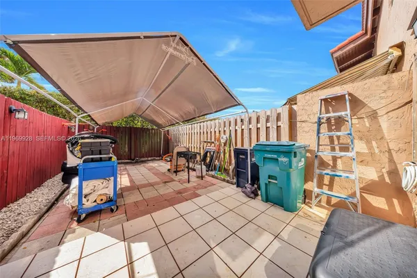 a view of a patio with table and chairs