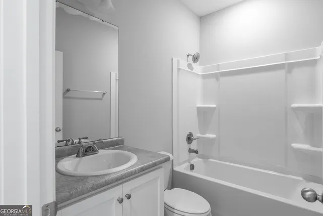 a bathroom with a sink toilet a bathtub and shower