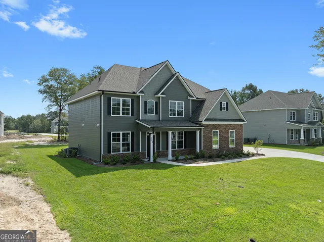 a front view of a house with garden
