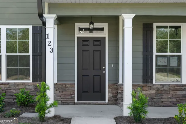 a front view of a house with a yard and windows