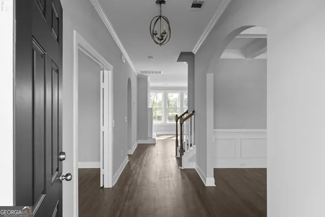 a view of hallway with wooden floor