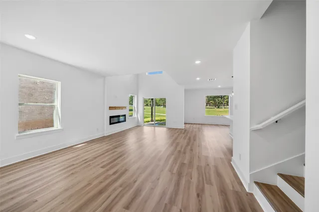 a view of a room with wooden floor and window