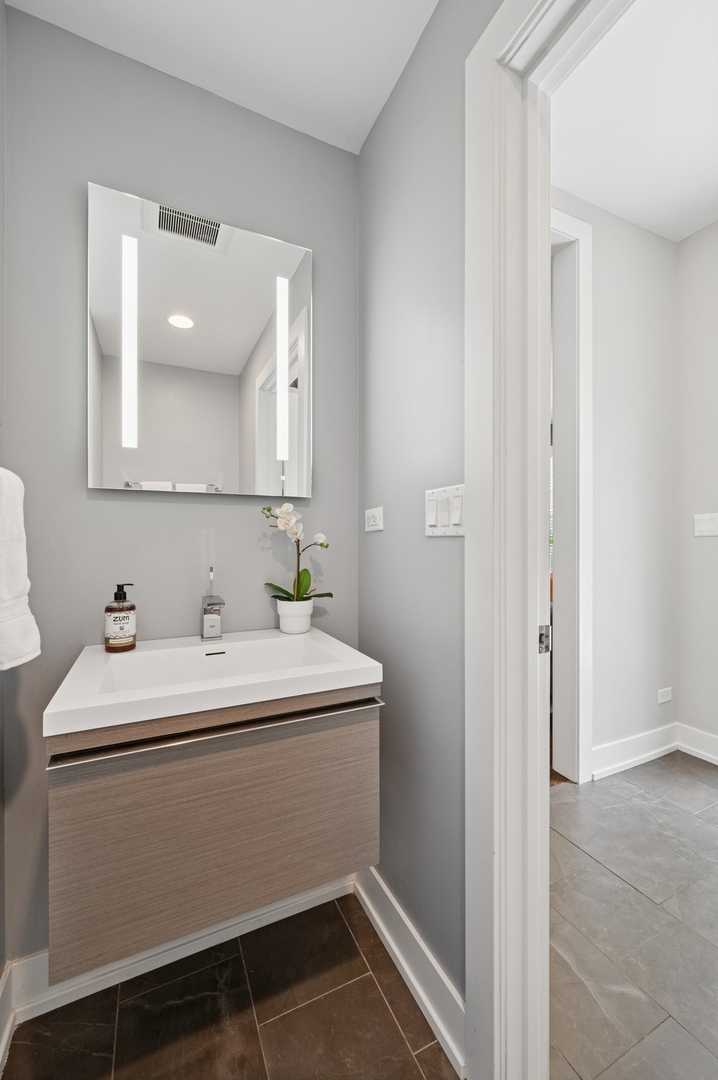 2119 Pioneer Road Evanston, IL 60201 - Photo 16 of 36 a bathroom with a sink and a mirror