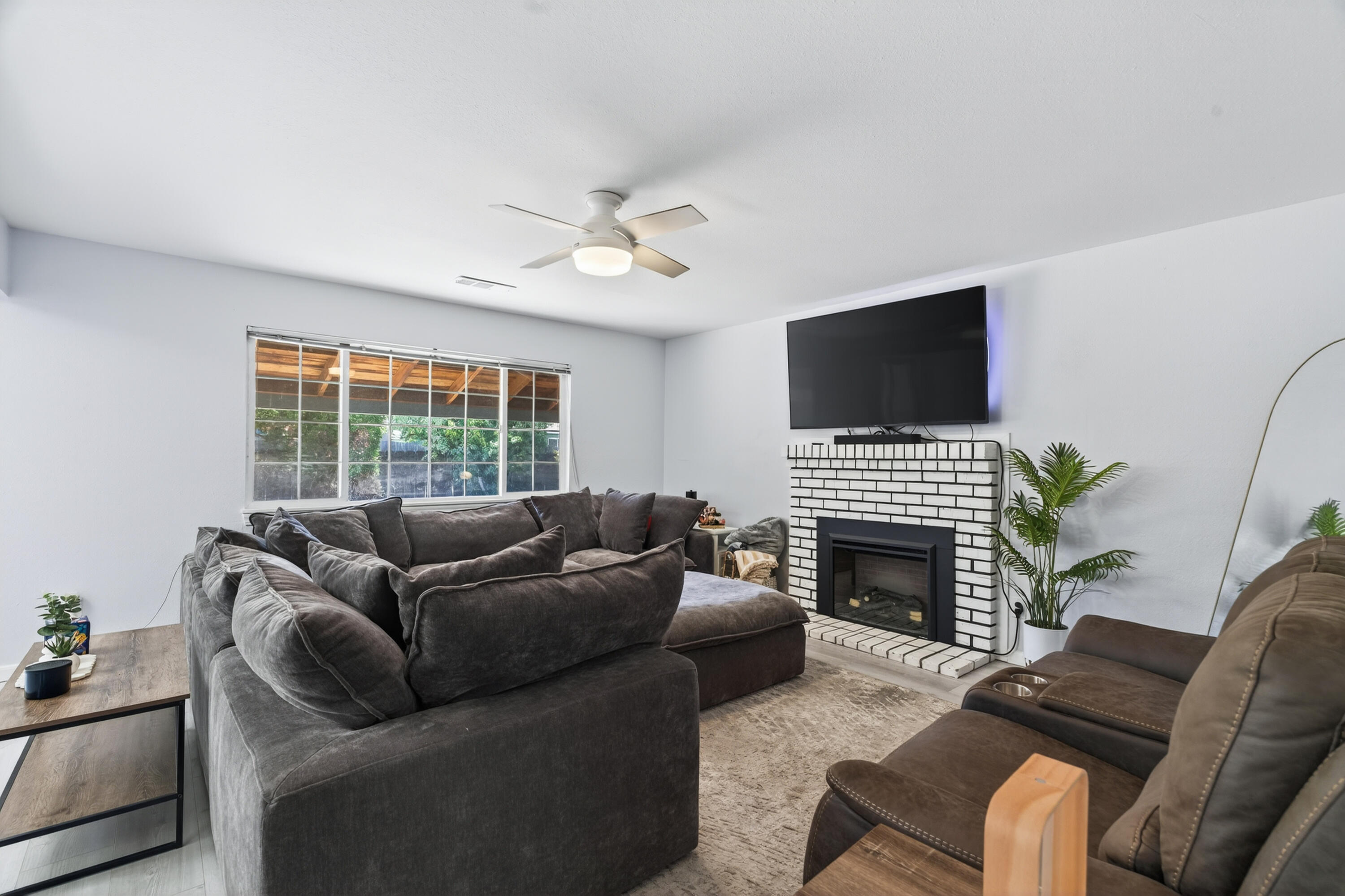 810 Cascade Avenue Red Bluff, CA 96080 - Photo 3 of 23 a living room with furniture a fireplace and a flat screen tv