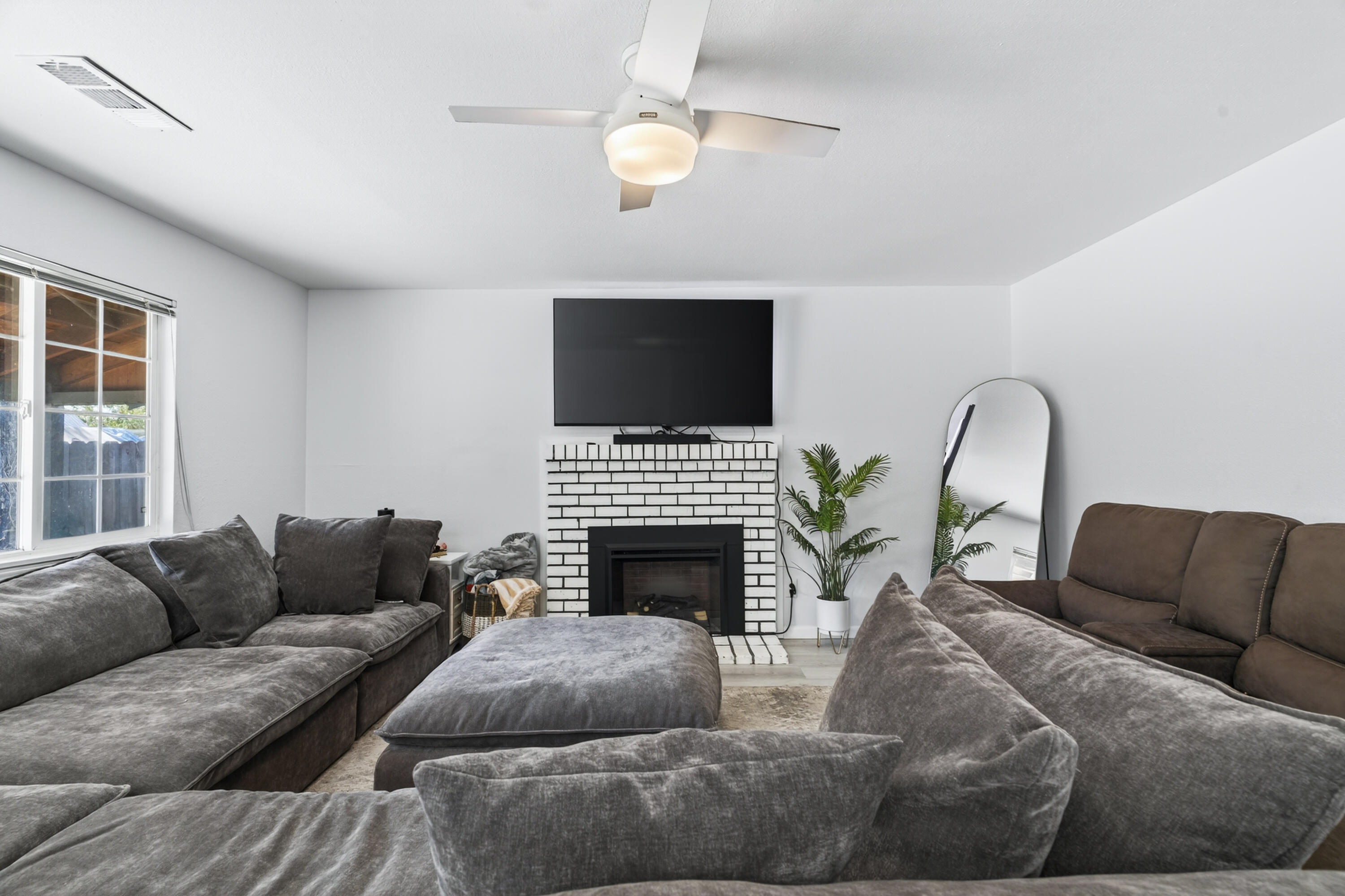 810 Cascade Avenue Red Bluff, CA 96080 - Photo 4 of 23 a living room with furniture a fireplace and a flat screen tv