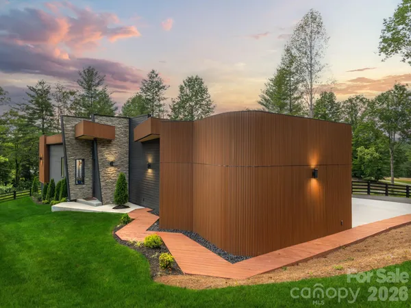 a backyard of a house with lots of green space and outdoor seating