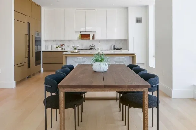 a kitchen with a table chairs microwave and cabinets
