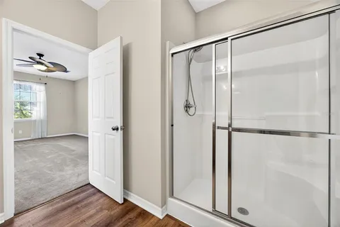 a bathroom with a glass shower door