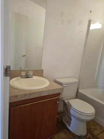 a view of a dirt road with a building in the background