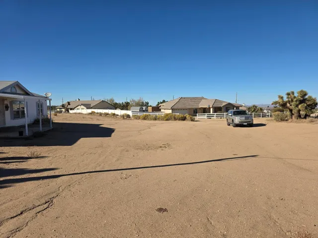 a room with kitchen island stainless steel appliances wooden floor and a counter top space