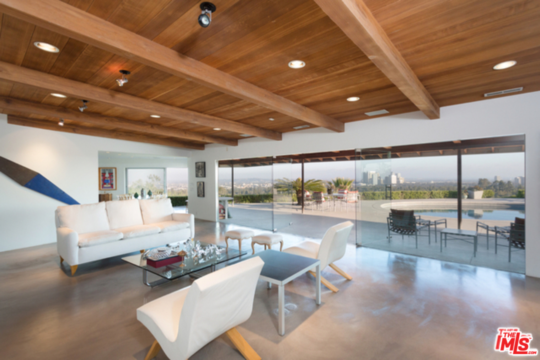 1230 Shadow Hill Way Beverly Hills, CA 90210 - Photo 11 of 22 a living room with furniture and a floor to ceiling window