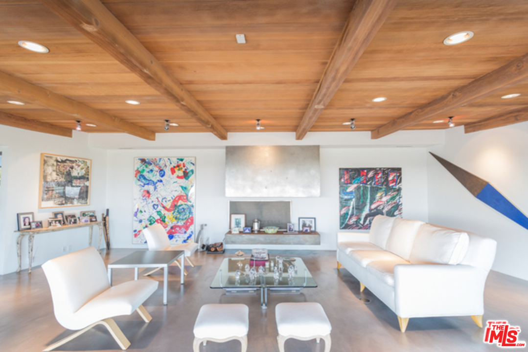 1230 Shadow Hill Way Beverly Hills, CA 90210 - Photo 12 of 22 a living room with furniture and a potted plant