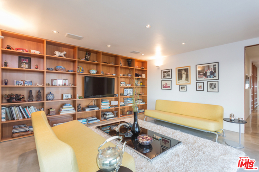 1230 Shadow Hill Way Beverly Hills, CA 90210 - Photo 16 of 22 a living room with furniture a rug and a flat screen tv