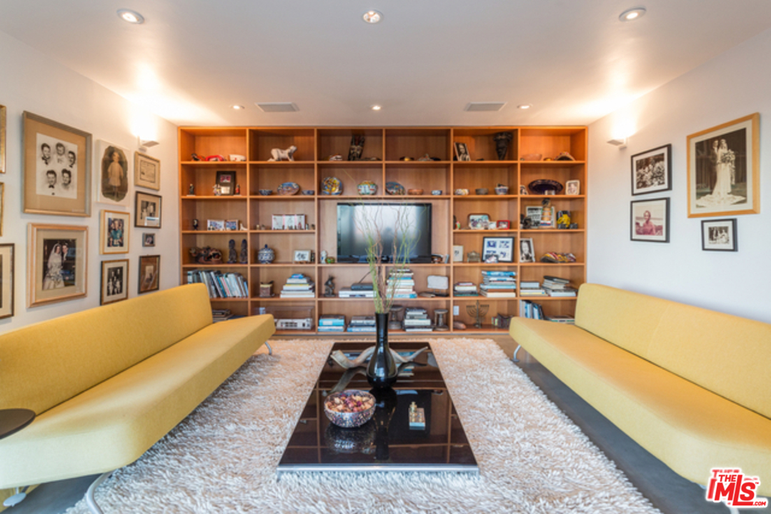 1230 Shadow Hill Way Beverly Hills, CA 90210 - Photo 17 of 22 a living room with furniture a rug and a flat screen tv