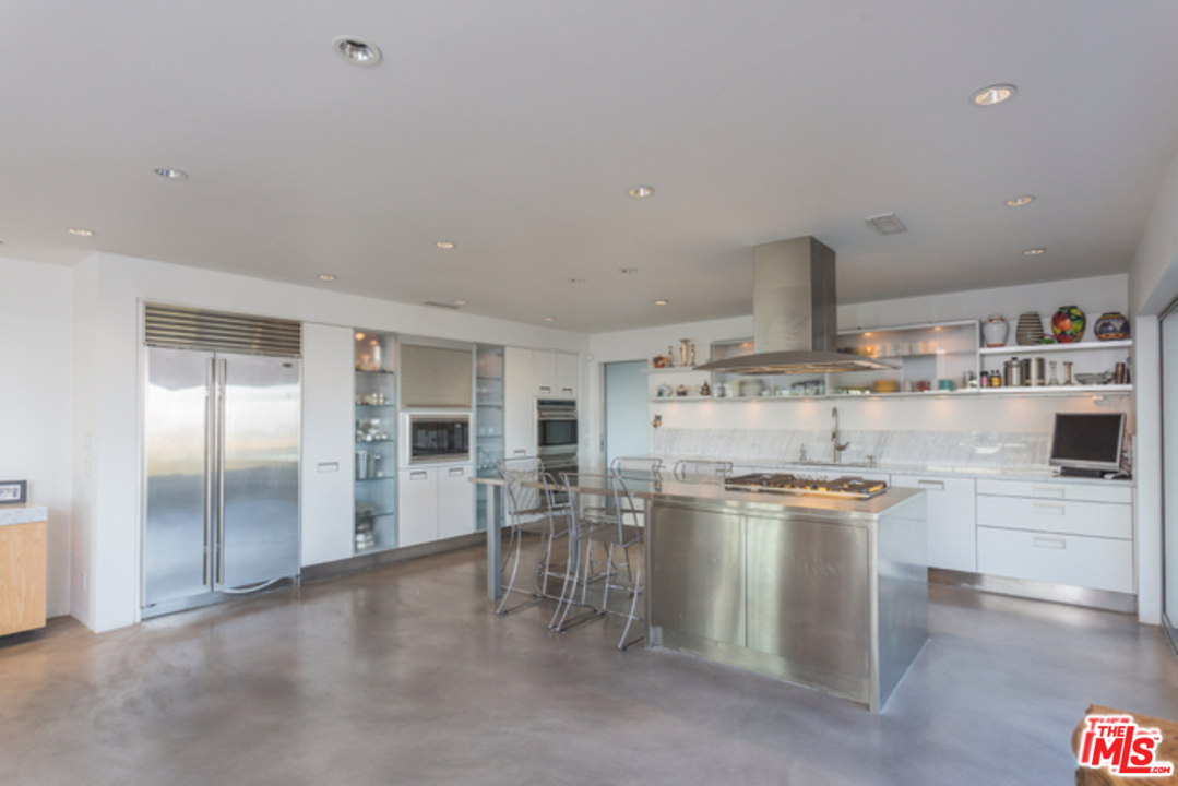1230 Shadow Hill Way Beverly Hills, CA 90210 - Photo 7 of 22 a kitchen with a stove and cabinets