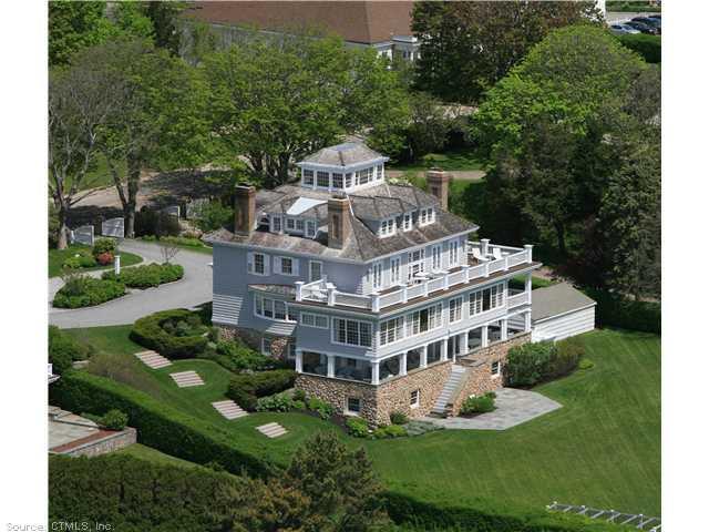 a large building with a big yard and large trees