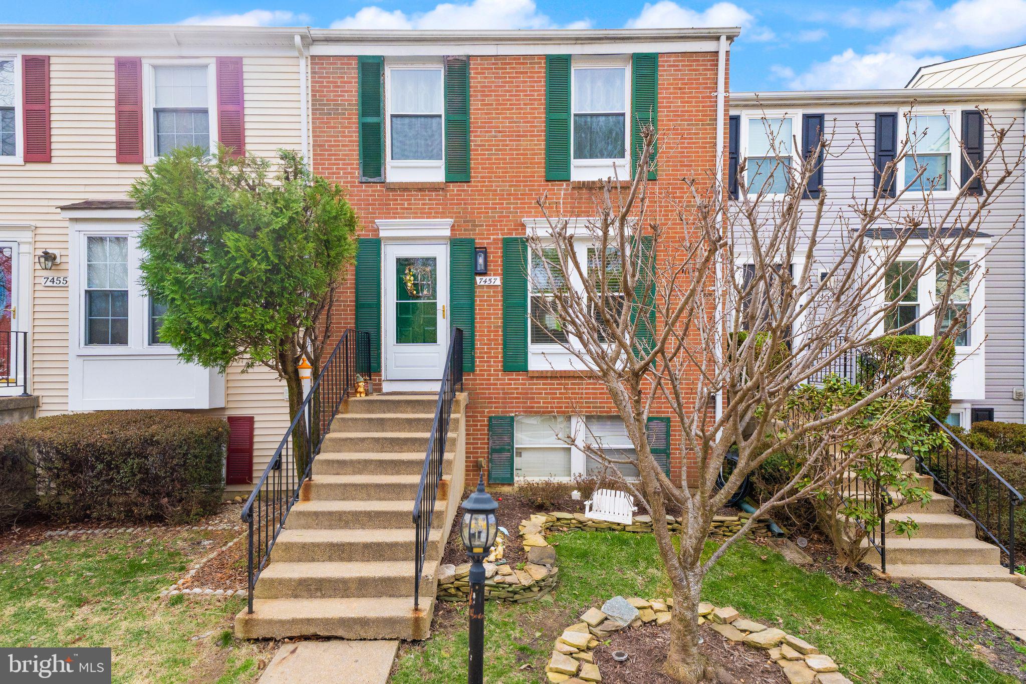7457 Wounded Knee Road Lorton, VA 22079 - Photo 1 of 49 a front view of a house with a garden