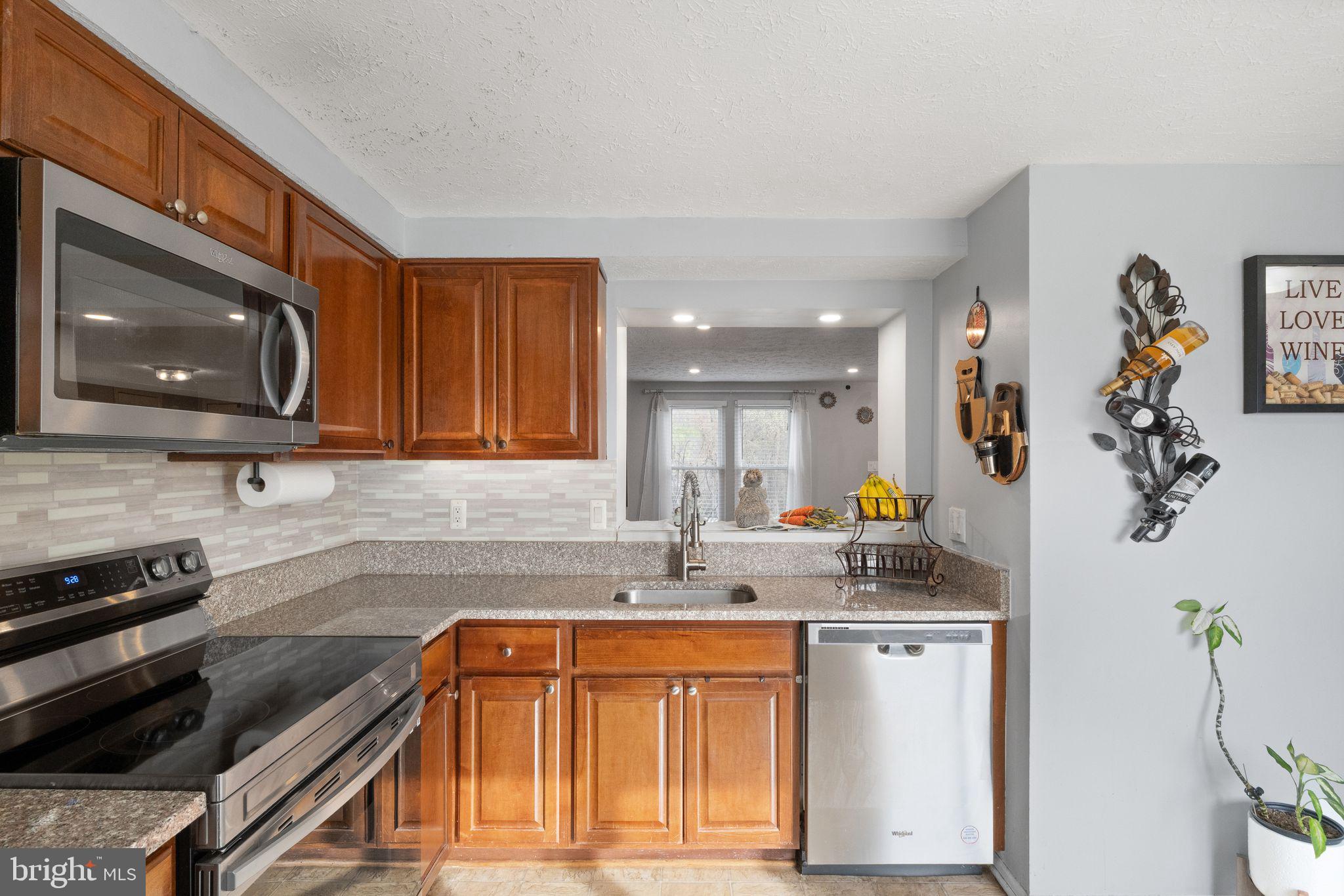 7457 Wounded Knee Road Lorton, VA 22079 - Photo 13 of 49 a kitchen that has a sink and a stove in it