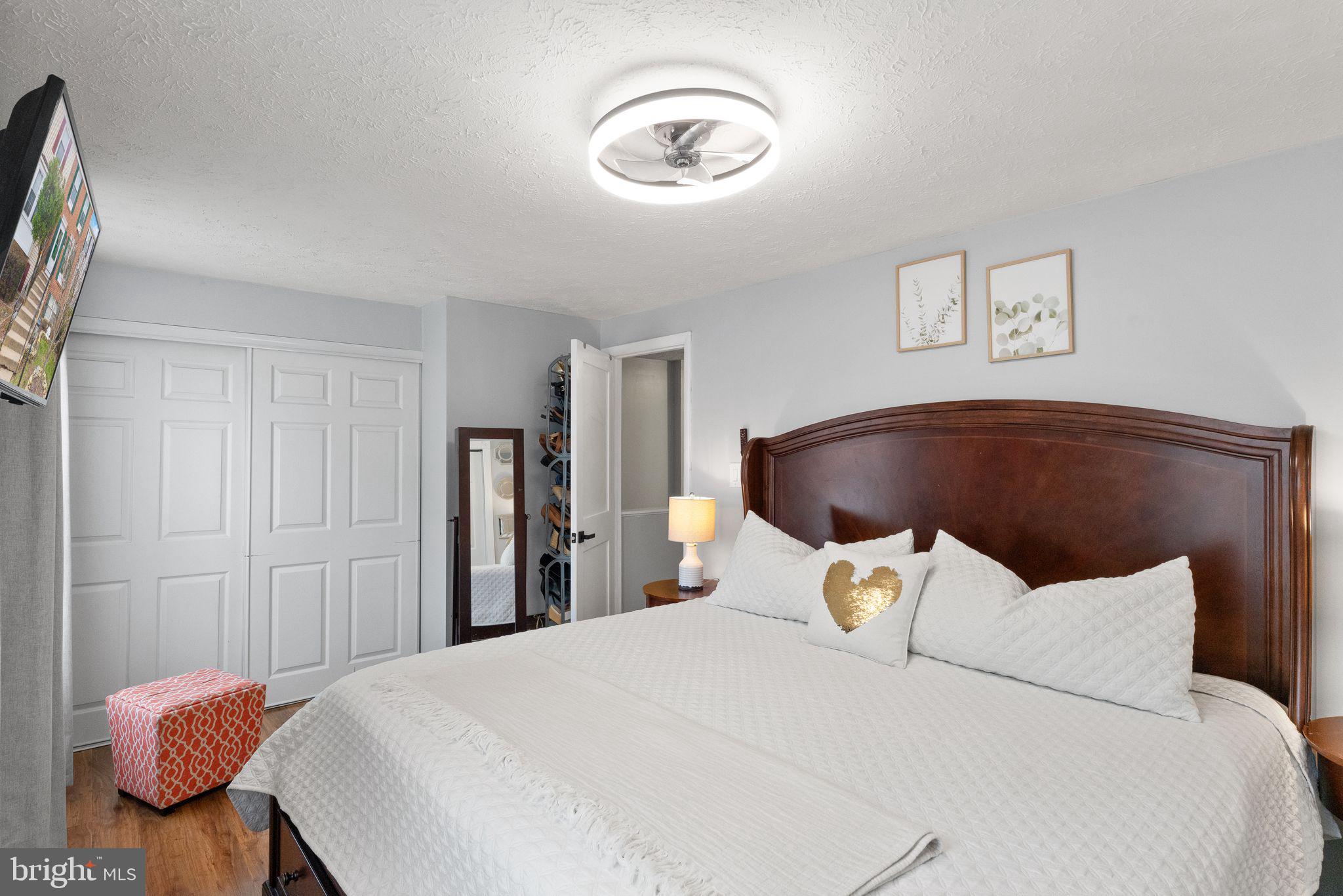 7457 Wounded Knee Road Lorton, VA 22079 - Photo 26 of 49 a bedroom with a bed and a chandelier