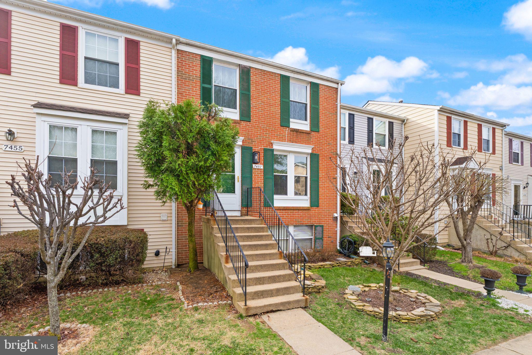 7457 Wounded Knee Road Lorton, VA 22079 - Photo 3 of 49 a front view of a house with a yard