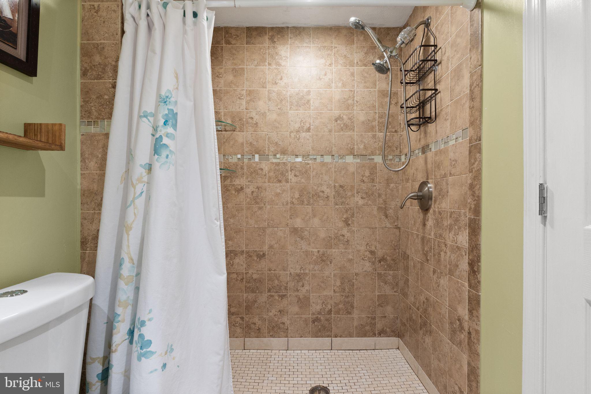 7457 Wounded Knee Road Lorton, VA 22079 - Photo 31 of 49 a bathroom with a shower and a toilet