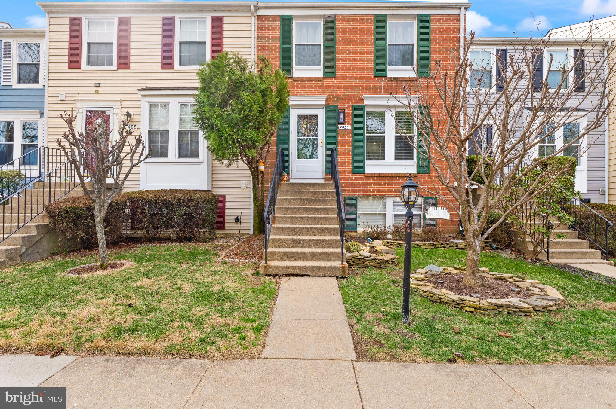 7457 Wounded Knee Road Lorton, VA 22079 - Photo 4 of 49 a front view of a house with a garden