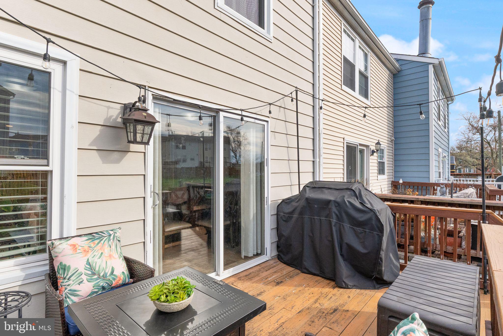 7457 Wounded Knee Road Lorton, VA 22079 - Photo 44 of 49 a view of a patio with couches table and chairs and potted plants