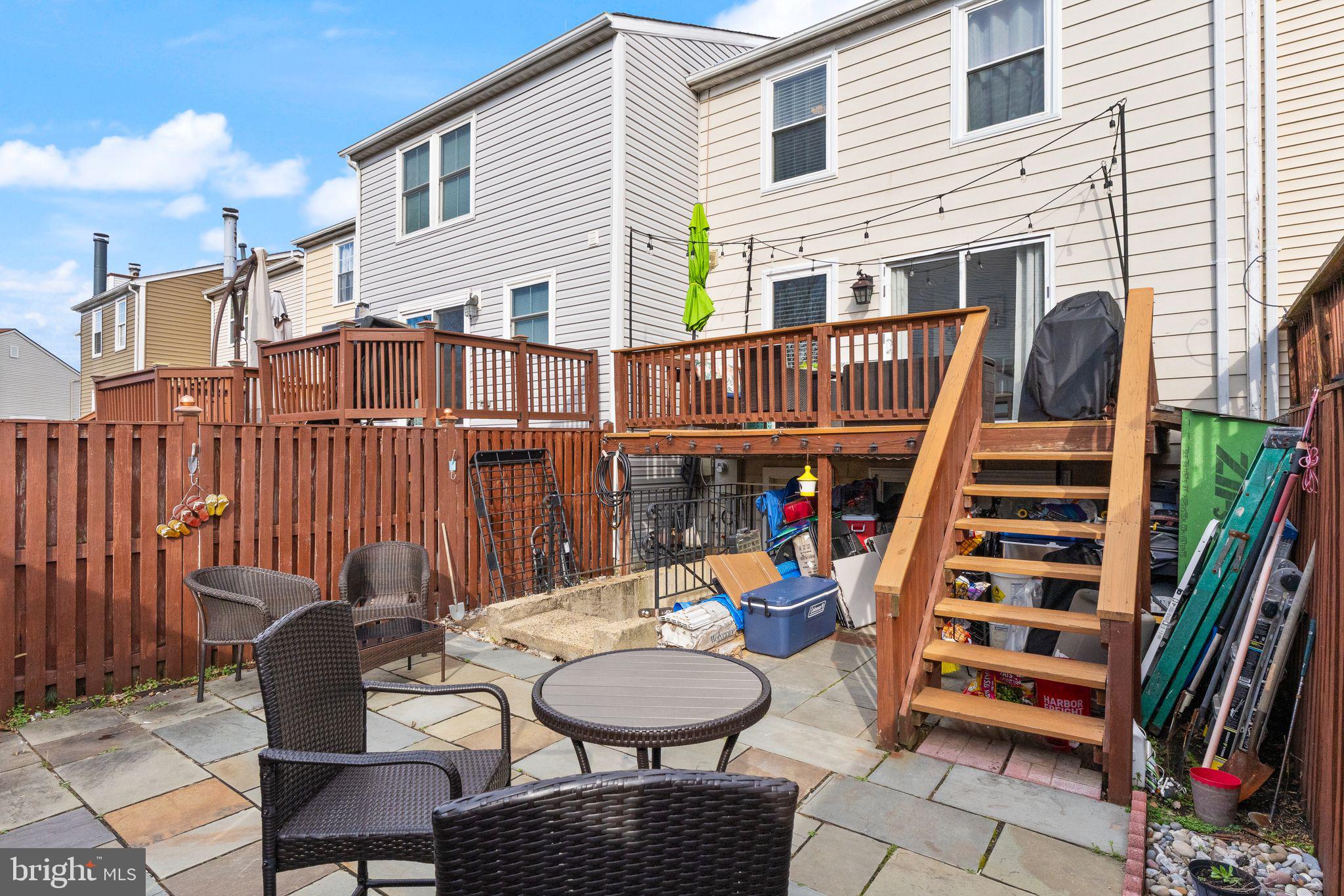 7457 Wounded Knee Road Lorton, VA 22079 - Photo 45 of 49 a view of a chairs and tables in the back yard of the house