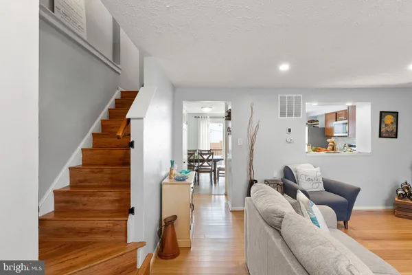 a living room with furniture and wooden floor