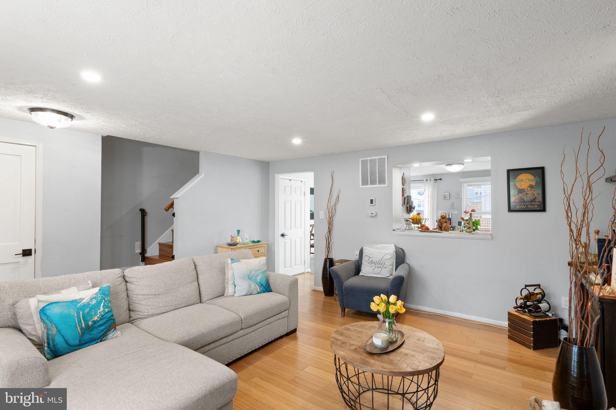 7457 Wounded Knee Road Lorton, VA 22079 - Photo 10 of 49 a living room with furniture and kitchen view