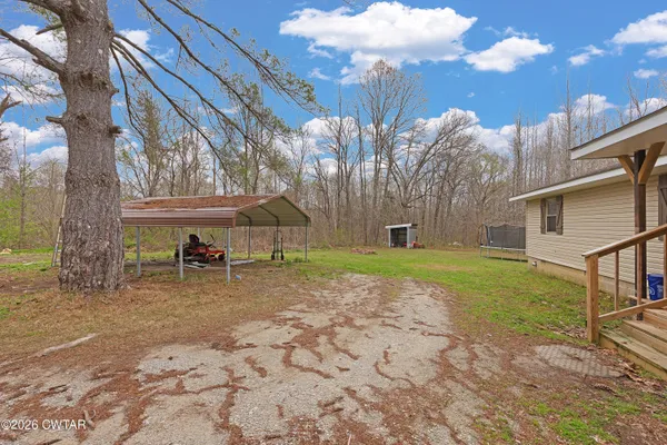 a view of a yard with a house in the background