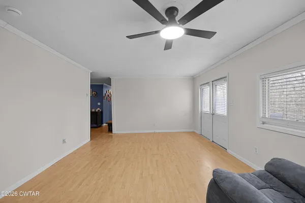 a view of livingroom with a ceiling fan and window