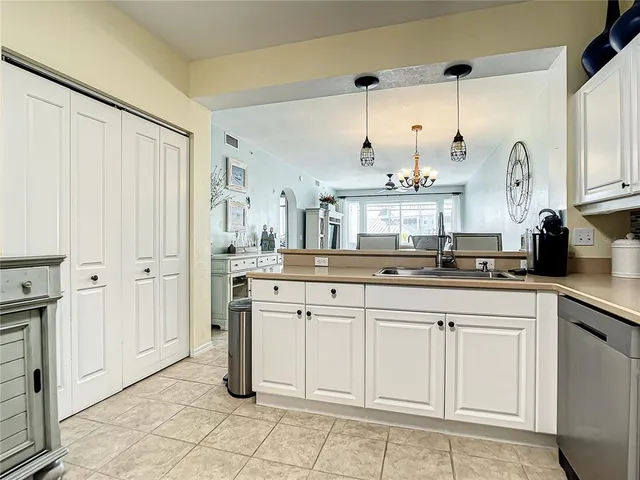 a kitchen with a stove sink and cabinets