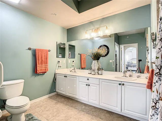 a bedroom with a bed and lamp on the table