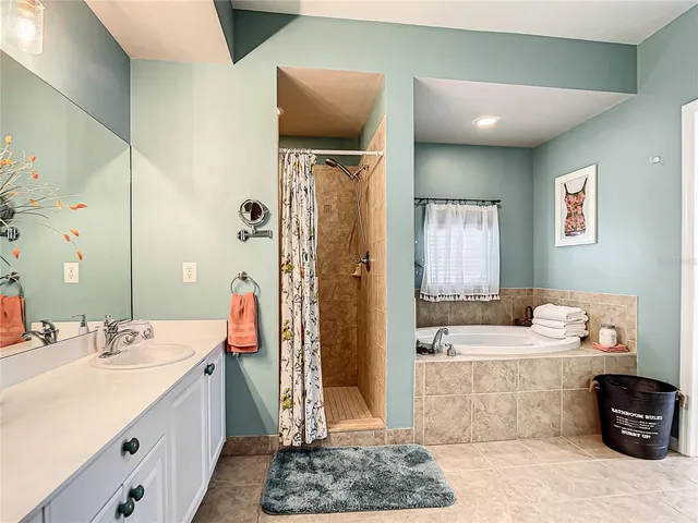a en suite bathroom with double vanity sink and a mirror