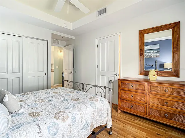 a bedroom with two beds and a chandelier