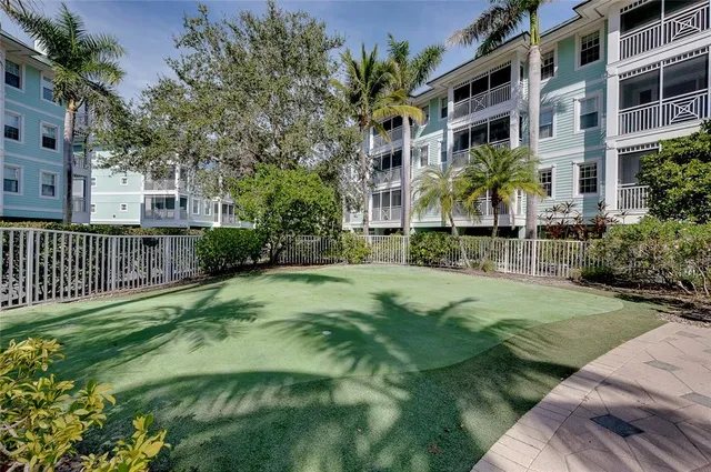 an aerial view of a house a yard and lots of trees