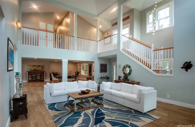 a living room with furniture a couch and a chandelier