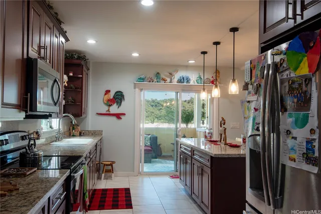 a kitchen with stainless steel appliances granite countertop a stove and a sink