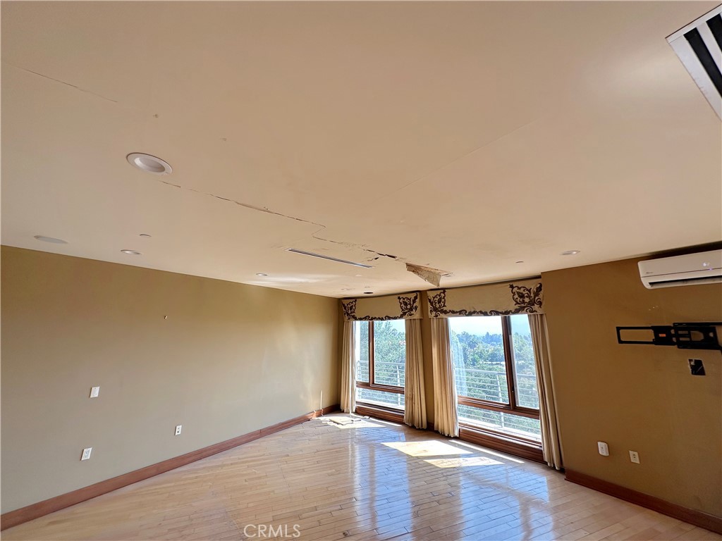 5077 Schumacher Road Calabasas, CA 91302 - Photo 25 of 58 a view of an empty room with a window