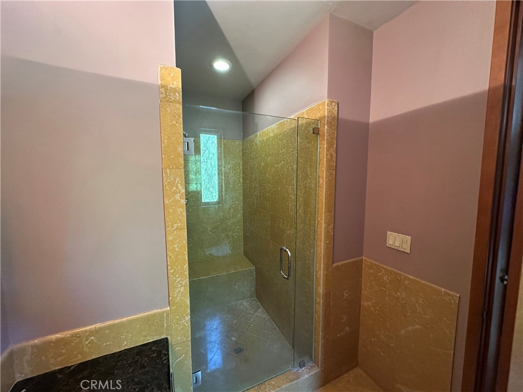 5077 Schumacher Road Calabasas, CA 91302 - Photo 27 of 58 a bathroom with a shower and a mirror