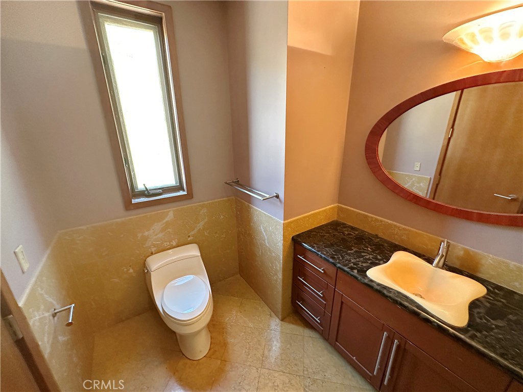 5077 Schumacher Road Calabasas, CA 91302 - Photo 29 of 58 a bathroom with a granite countertop sink and a mirror