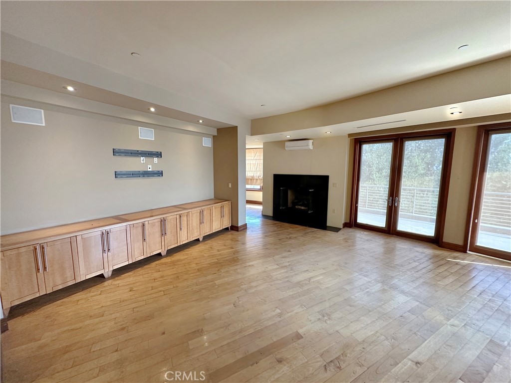 5077 Schumacher Road Calabasas, CA 91302 - Photo 36 of 58 a view of an empty room with a fireplace and a window