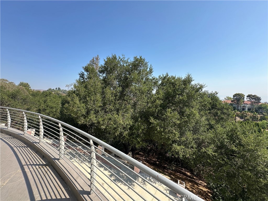 5077 Schumacher Road Calabasas, CA 91302 - Photo 4 of 58 a view balcony with wooden floor and fence